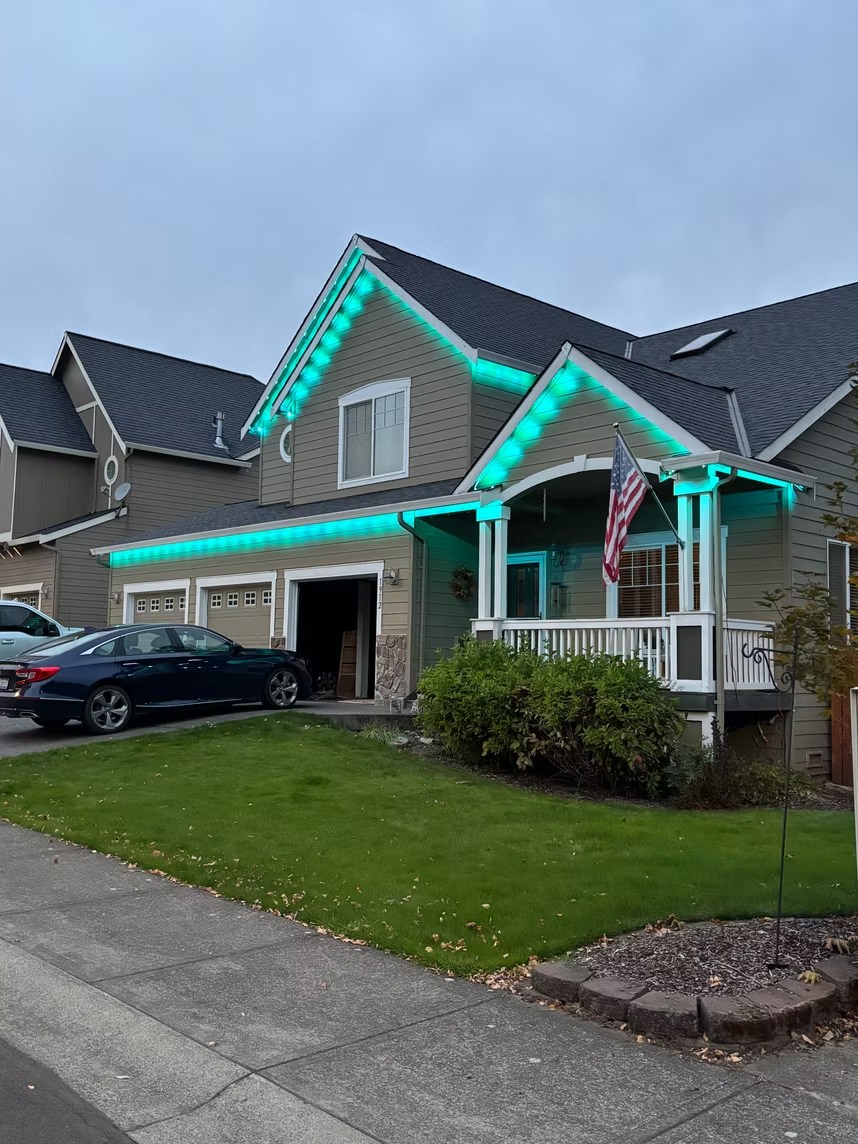 Turquoise roofline lights on a two-story home in daylight